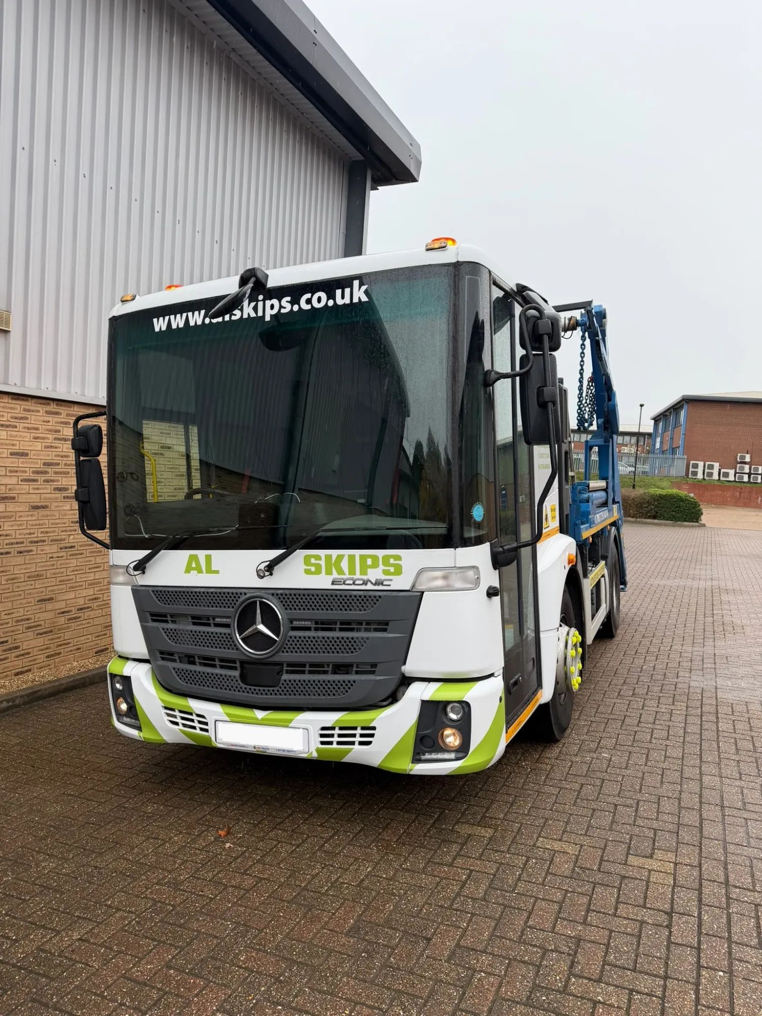 Front of the white AL Skips Mercedes Econic skip lorry